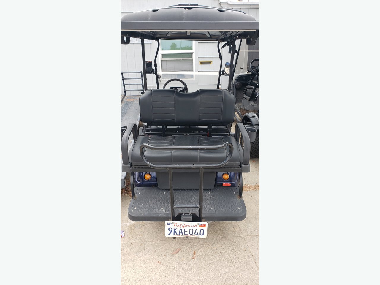 Evolution 2+2 — rear view with flip-down seat and CA plate